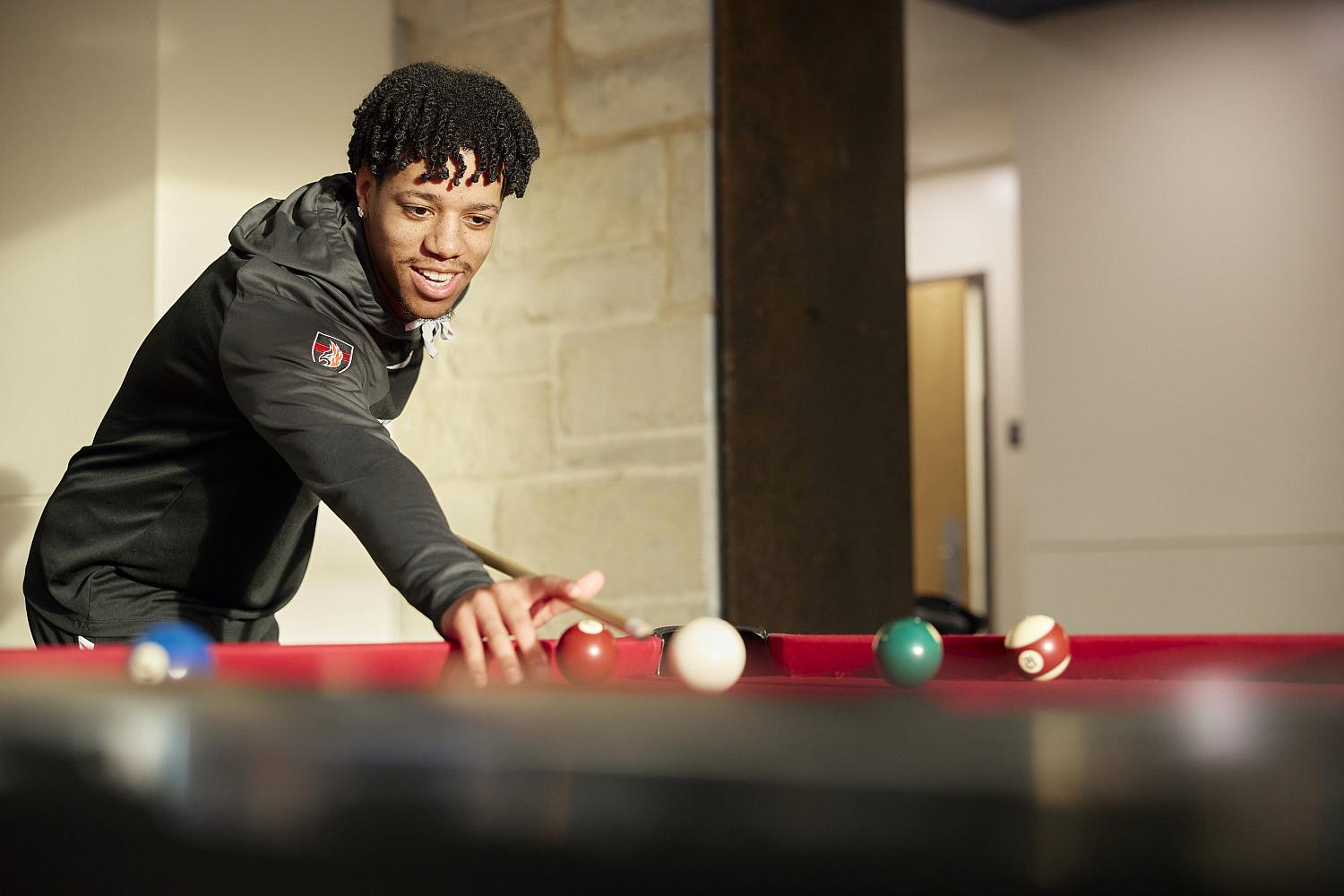 Carthage students play pool and foosball in the Campbell Student Union.